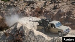 FILE - A fighter of the Syria Democratic Forces mans an anti-aircraft weapon in the southern rural area of Manbij, in Aleppo Governorate, Syria, May 31, 2016. 