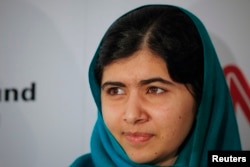FILE - Pakistan's Malala Yousafzai poses during a photo opportunity before speaking at an event in New York, Oct.10, 2013.