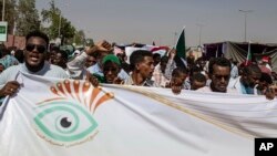 FILE - Protesters chant against military rule and demand the prosecution of former officials, at the Armed Forces Square, in Khartoum, Sudan, April 28, 2019.