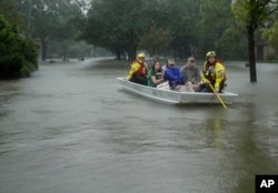A FEMA rescue team evacuates people from a neighborhood inundated by floodwaters from Tropical Storm Harvey in Houston, Aug. 28, 2017.