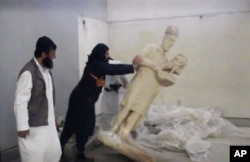 FILE - A five-minute video from the Islamic State group purports to show militants destroying ancient artifacts in Iraq’s Mosul Museum. It was released Feb. 26, 2015.