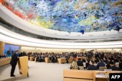 UN Secretary-General Antonio Guterres, left, delivers a speech at the opening day of the 40th session of the United Nations Human Rights Council, Feb. 25, 2019 in Geneva.