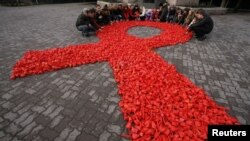 A red ribbon, the symbol of the worldwide campaign against AIDS.