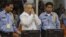 FILE - Former Khmer Rouge S-21 prison chief Duch (C) greets the court during his appeal hearing at the Court Room of the Extraordinary Chambers in the Courts of Cambodia (ECCC) on the outskirts of Phnom Penh, Feb. 3, 2012. 