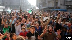 Syrians gather in a street in the northern city of Aleppo on Aug. 6, 2016, in celebrations after rebels said they have broken a three-week government siege on Syria's second city. 