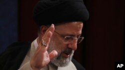 Presiden baru Iran, Ebrahim Raisi, melambaikan tangan usai konferensi pers di Teheran, Iran, 21 Juni 2021. (AP Photo/Vahid Salemi)