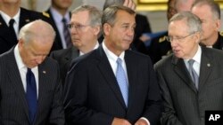 FILE - From left: Vice President Joe Biden, Senate Minority Leader Mitch McConnell, House Speaker John Boehner, Senate Majority Leader Harry Reid, Capitol Rotunda, Washington, Dec. 20, 2012.