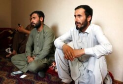Ramal Ahmadi, right, speaks during an interview with AP about a U.S. drone strike in Kabul, Afghanistan, Sept. 2, 2021. Ahmadi said the strike killed 10 members of his family.