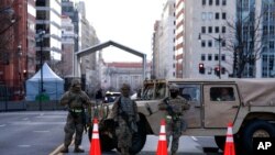 Members of the National Guard secure a checkpoint in downtown Washington, ahead of President-elect Joe Biden's inauguration ceremony, Jan. 18, 2021.