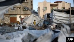 8일 가자지구 중부 부레이지 난민 캠프에 이스라엘 공습 이후 파괴된 텐트 옆에 서 있는 어린이의 모습.