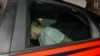 American teenager Finnegan Lee Elder, who was allegedly questioned in the case of a slain Carabinieri policeman, is seen on a Carabinieri car as it leaves a police station, in Rome, Italy, July 27, 2019.