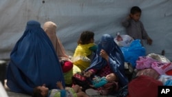 Beberapa keluarga pengungsi Afghanistan menunggu di kantor PBB untuk Urusan Pengungsi (UNHCR) untuk mendaftar pemulangan ke Afghanistan, di Peshawar, Pakistan, 27 April 2017.