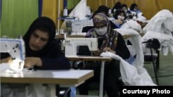 FILE - Iranian women work in a factory in this undated photo from Iranian state news agency IRNA.