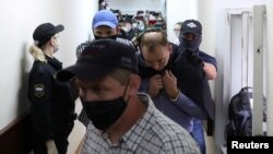 Ivan Safronov, a former journalist who works as an aide to the head of Russia's space agency Roscosmos, detained on suspicion of treason is escorted before a court hearing in Moscow, Russia, July 7, 2020. 