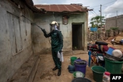 A worker of Anglogold Ashanti Malaria Ltd sprays the walls of a house with insecticide against mosquitos, May 2, 2018 in Adansi Domeabra, near Obuasi, Ashanti Region, Ghana.