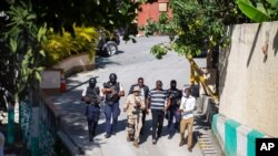 Security forces investigate the perimeters of the residence of Haitian President Jovenel Moise, in Port-au-Prince, Haiti, July 7, 2021. Gunmen assassinated Moise and wounded his wife in their home early Wednesday. 