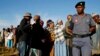 FILE - A police officer looks on at a voting station during the Lesotho national election in Magkhoakhoeng village outside the capital Maseru , Feb. 28, 2015. 