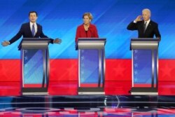 Democratic presidential candidates former South Bend, Indiana Mayor Pete Buttigieg, left, Sen. Elizabeth Warren (D-MA) and former Vice President Joe Biden participate in the Democratic presidential primary debate, Feb. 7, 2020, in Manchester, N.H.