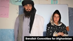 Mia Khan standing next to his daughter, Rozai. (Courtesy: Swedish Committee for Afghanistan)
