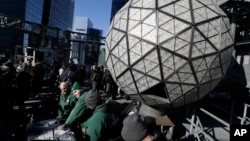 Workers prepare to install the last panels on the New Year's Eve ball above Times Square, New York, Dec. 27, 2017. The 12-foot diameter ball carries more than 2,600 Waterford crystals and is lighted by more than 32,000 LEDs.