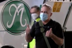 In this image made from a video, The Australian Financial Review journalist Michael Smith speaks to the media on his arrival at Sydney airport, Australia, Sept. 8, 2020.