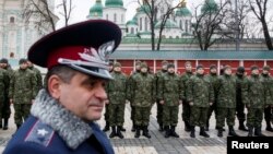 Members of the newly created Ukrainian interior ministry battalion "Saint Maria" take part in a ceremony before heading to military training, in front of St. Sophia Cathedral, in Kyiv, Feb. 3, 2015. 