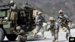 FILE - U.S. Army soldiers from the 25th Infantry Division's 2nd Stryker Brigade Combat Team and South Korean soldiers take part in an annual joint military exercise at the Rodriquez Multi-Purpose Range Complex in Pocheon, north of Seoul, South Korea, March 25, 2015.