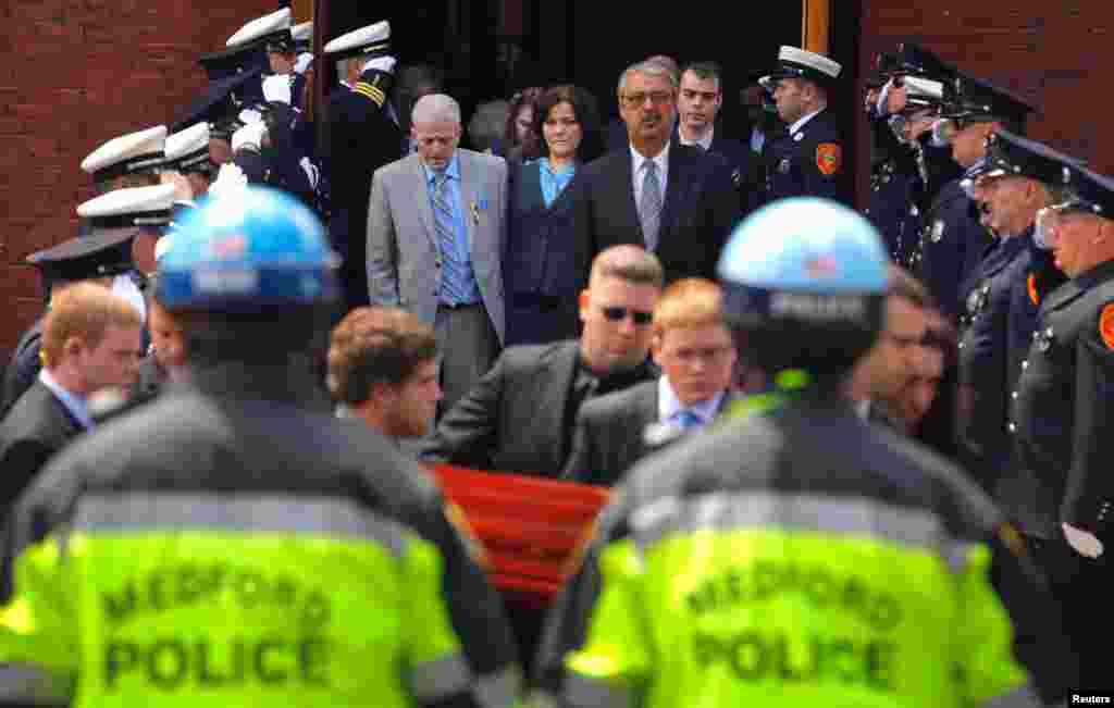 Patty Campbell watches as the casket containing the body of her daughter Krystle, one of the victims of the marathon bombing, is carried out of St. Joseph Church in Medford, Massachusetts, April 22, 2013.