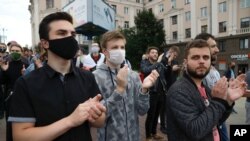 People applaud during a protest rally against the removal of opposition candidates from the presidential elections in Minsk, Belarus, July 14, 2020.