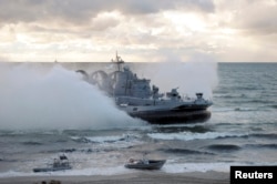 FILE - A military vessel is seen during the joint war games Zapad-2013 (West-2013), at the Khmelevka range on Russia's Baltic Sea in the Kaliningrad Region, Sept. 26, 2013. The Zapad 2017 exercises are set for September.
