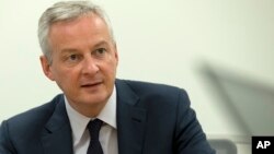 FILE - French Finance Minister Bruno Le Maire speaks during a news conference on the side lines of the World Bank/IMF Annual Meetings in Washington, Oct. 18, 2019.