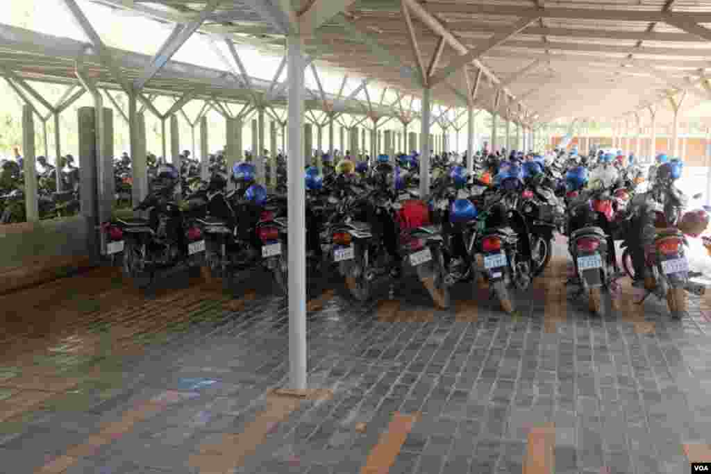 A covered parking lot for employees -- most of whom have traded in their bicycles for motorized transport. (S. Herman/VOA)