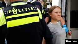 Swedish climate campaigner Greta Thunberg is detained by police as climate activists try to block the A12 highway in protest of Dutch government subsidies for fossil fuels, in The Hague, Netherlands, April 6, 2024.