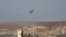FILE - A picture taken Oct. 18, 2019, from the Israeli side of the border at the Jordan Valley site of Naharayim, shows a Jordanian flag flying over a military outpost. 
