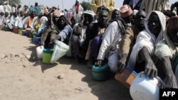 FILE - Internally displaced persons wait to be served with food at Dikwa camp, in northeast Nigeria's Borno state, Feb. 2, 2016. The U.N is hoping to raise $1 billion to meet the needs of nearly seven million victims of the Boko Haram insurgency in northeast Nigeria.