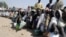 FILE - Internally displaced persons wait to be served with food at Dikwa camp, in northeast Nigeria's Borno state, Feb. 2, 2016.
