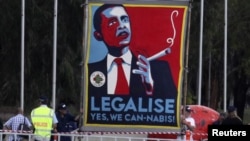 FILE - Marijuana activists use a sign to call on President Barack Obama to make the drug legal. Reuters