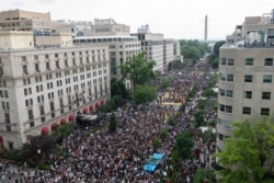 The Washington Monument and the White House are visible as protesters gather in Washington,June 6, 2020, over the death of George Floyd.