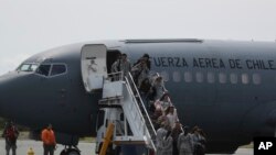 Relatives of passengers of a missing military plane arrive in a Chilean military airplane to an airbase in Punta Arenas, Chile, Dec. 11, 2019. 