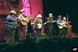 FILE - Ricky Skaggs and Rhonda Vincent perform with Ralph Stanley and the Clinch Mountain Boys Thursday, Oct. 22, 1998, to begin the ninth International Bluegrass Music Association Awards Show at the Kentucky Center for the Arts in Louisville.