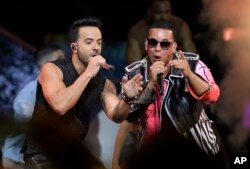 FILE - Singers Luis Fonsi, left and Daddy Yankee perform during the Latin Billboard Awards in Coral Gables, Florida.