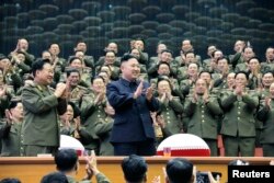 Military officials applaud with North Korean leader Kim Jong Un, during the Unhasu concert in Pyongyang, in a photo released April 16, 2013. (KCNA)
