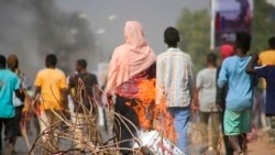 Pro-democracy protesters use fires to block streets to condemn a takeover by military officials in Khartoum, Sudan, Oct. 25, 2021.