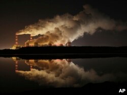 FILE - Clouds of smoke over Europe's largest lignite power plant in Belchatow, central Poland, on Wednesday, Nov. 28, 2018.