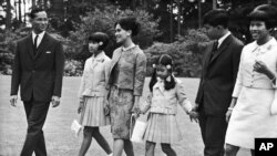 The Thailand Royal Family walks through the gardens of their residence at Sunninghill, Berkshire, United Kingdom on July 27, 1966 where they are staying during their private visit to Britain.