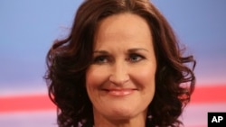 Eva Glawischnig, chairwoman of the Green party, smiles after arriving in a TV studio in the Hofburg in Austria's capital Vienna Sunday, Dec. 4, 2016.