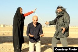 The Arta FM staff performs a mock IS-style execution. (Courtesy - Arta FM)