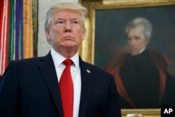 President Donald Trump waits in the Oval Office of the White House, Oct. 24, 2017.