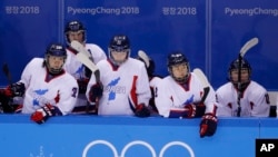 North Korea's Jin Ok (32), of the combined Koreas team, joins teammates Park Yoonjung (23), Park Ye-eun (11), Kim Selin (8), and Kim Heewon (12) during the third period of the classification round of the women's hockey game at the 2018 Winter Olympics in