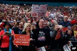 Supporters of Republican presidential candidate Donald Trump speaks during a campaign rally, Nov. 6, 2016, in Sterling Heights, Mich.